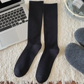 Calze a compressione nere minimaliste da donna presentate in una scena di ufficio a casa - Nero