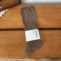 Coffee brown vertical ribbed crew socks with white paper wrap packaging on wood surface - One Size / Coffee
