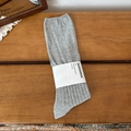 Grey ribbed cotton crew socks with paper band packaging on a warm wooden surface - One Size / Light Gray
