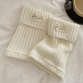 White ribbed knit leg warmers with folded cuffs and a decorative label for winter - One Size / Cream