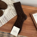 Dark brown wool knit socks with retro twist patterns on a cozy wooden background - One Size / Coffee