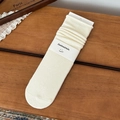 Creamy white vintage cotton crew socks with ribbed cuffs on a brown wooden background - One Size / Cream