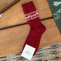 Deep red Fair Isle wool socks with white reindeer and snowflake knit patterns - Red