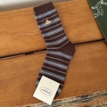Brown mid-calf socks with light blue stripes and dog embroidery on a wooden surface - Stripe Dog
