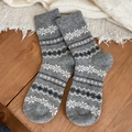Thick wool socks with gray Fair Isle snowflake pattern on rustic wooden surface - One Size / Light Gray