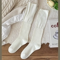 Ribbed knit white calf socks in ballet style shown on a cozy textured background - Cream