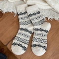 Thick wool socks for women featuring Nordic Fair Isle snowflake patterns in beige and grey - One Size / Beige