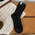 Cozy black wool mid-tube socks with vertical ribbed texture and white woven label detail - One Size / Wide Black Stripe