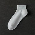 Breathable white cotton sports ankle socks with elastic ribbed cuffs on grey background - One Size / White