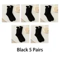 Five-pack of black crew socks with ribbed cotton texture and white fabric labels - One Size / Black 5 Pairs Pack