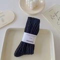 Thick black knitted crew socks with vertical texture and decorative paper band packaging - One Size / Black