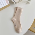 Vertical striped beige cotton crew socks with black lettering logo on a white surface - One Size / Beige