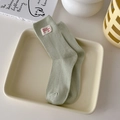 Ribbed mint green mid-calf socks with white cloth label and red embroidered letter details - One Size / Milky Green