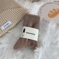 Winter set with beige ribbed knit beanie and dark brown thick crew socks on plush background - One Size / Khaki