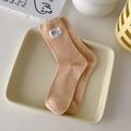 Japanese style apricot ribbed crew socks with Hello Nice Day label in a ceramic tray - One Size / Milk Apricot