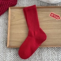Festive bright red ribbed cotton mid-calf socks displayed on a wooden tray decor - Red Ribbed Vertical Stripe Style