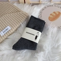 Deep grey winter cotton socks in minimalist packaging on a soft white plush rug - One Size / Dark Gray