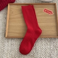 Festive red rib-knit crew socks for Lunar New Year displayed on a wooden tray - Red Thick Ribbed Knit Style