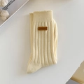 Creamy ribbed knit mid-calf crew socks featuring a vintage brown leather label detail - One Size / Milky Yellow