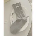 Light grey crew socks with white polka dots and 'I dig you' label on a white ceramic plate - Light Gray