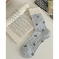 Light blue crew socks with white ruffled lace trim and delicate floral embroidery pattern - One Size / Creamy Blue Floral