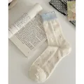 Cream white crew socks with grey polka dots and blue ruffled edges in a cozy flat lay style - One Size / Creamy Polka Dots
