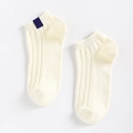 Creamy white ribbed ankle socks with a navy blue label tag in a minimalist style - One Size / Off-white