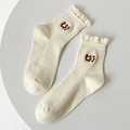 Calze bianco crema con bordi a volant e ricami floreali in maglia a coste verticali - Taglia unica / Bianco Crema