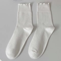 White cotton crew socks with ruffled lettuce edge and ribbed knit texture for women - White