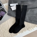 Classic black wool-blend knit knee-high socks shown on a white textured background - Black