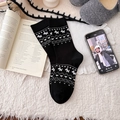 Black mid-calf knit socks with white Nordic geometric horse pattern for cozy winter style - Black