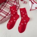 Festive red crew socks for women featuring white heart patterns and a ribbed cuff design - White Love Heart Jacquard Style