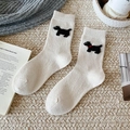 Cream wool socks with cute black dog pattern and ribbed cuffs for winter warmth - Cream