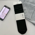 Mid-calf black wool socks in ribbed knit with stylish minimalist branded packaging - Black
