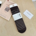 Deep brown striped wool socks presented in minimalist white packaging on a wooden surface - One Size / Coffee