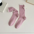 Pink ribbed crew socks featuring delicate white ruffle edges and satin bow detail - Pink