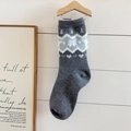 Dark gray knitted socks with festive patterns and white fleece trim on a hanger - One Size / Fair Isle Snowflake Pattern