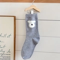 Grey wool-like crew socks featuring a cute white cartoon dog motif on a wooden hanger - One Size / Dog Pattern Style