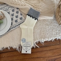 Vertical ribbed cotton mid-calf socks in beige and grey color block with ruffled wavy trim - Creamy White