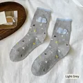 Light grey crew socks featuring 3D blue cloud patch and colorful star patterns - Light Gray