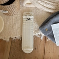 Beige ribbed knee-high socks with ruffle edges and black bow accent on display card - One Size / Beige Cable Knit with Bow (1 Pair)