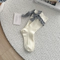 Cream white mid-calf socks featuring black plaid bow and ruffled edges in sweet style - One Size / Creamy White