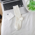 White mid-calf cotton socks with rib-knit texture on a white grid fabric background - One Size / White