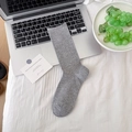 Minimalist grey mid-calf slouch socks with ribbed cuffs on a laptop desk setup - One Size / Light Gray