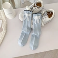 Light blue crew socks with white lace bow and pearl detail over white shoes - Blue