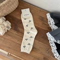 Creamy white crew socks with black floral pattern and vintage bow lace accents - Milky White Floral