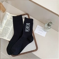 Sweet black crew socks featuring white lace patches and elegant ribbon bows - One Size / Black