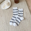 White ribbed cotton crew socks with blue-black stripes and egg brand label detail - White