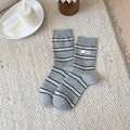 Gray striped mid-calf socks with 'egg' tag on cozy knit texture background - Light Gray