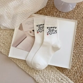 White crew socks featuring a cute puppy graphic and black PUPPY text in cotton blend - Running Puppy Style